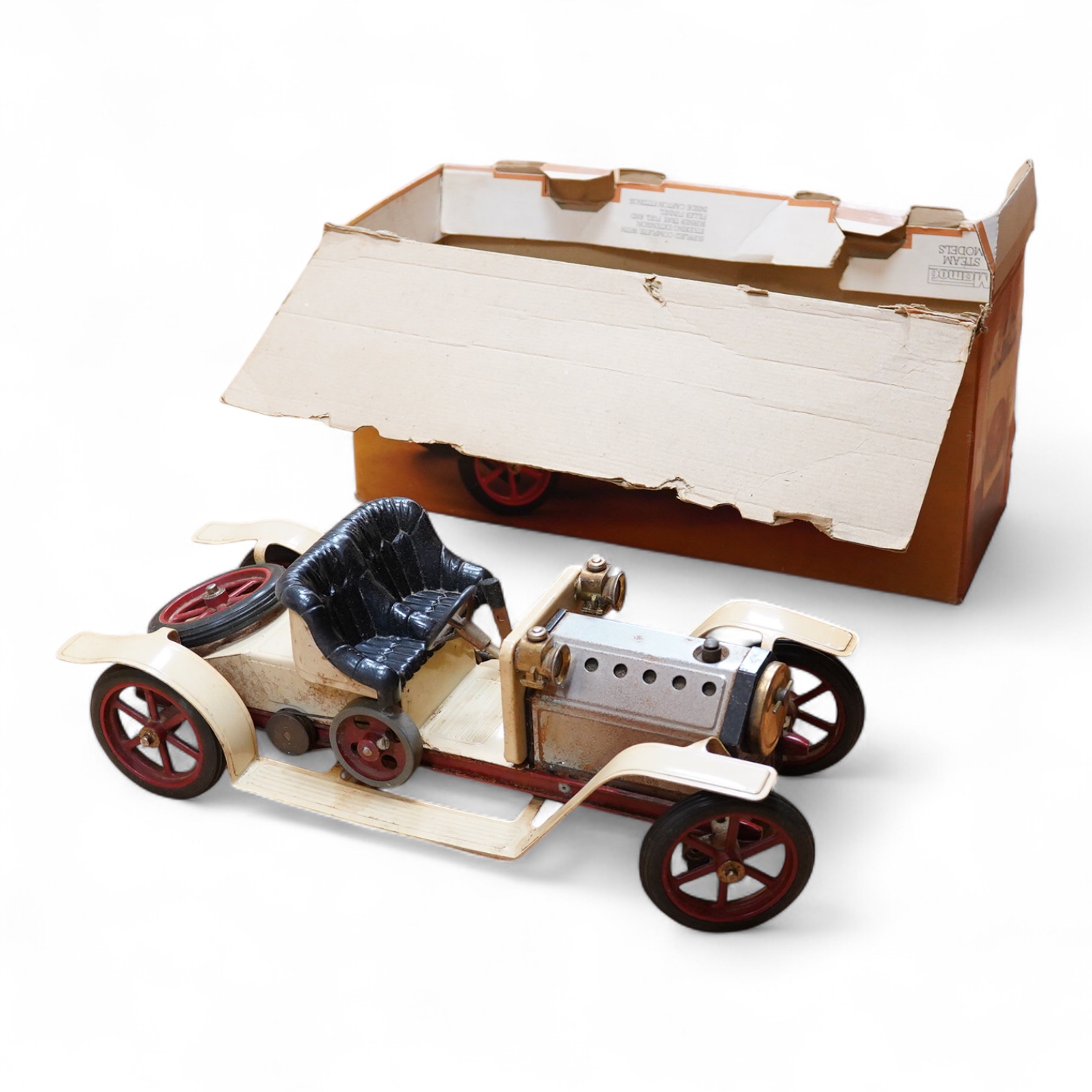 A boxed Mamod Steam Roadster, live steam, single cylinder cream painted car, together with some accessories